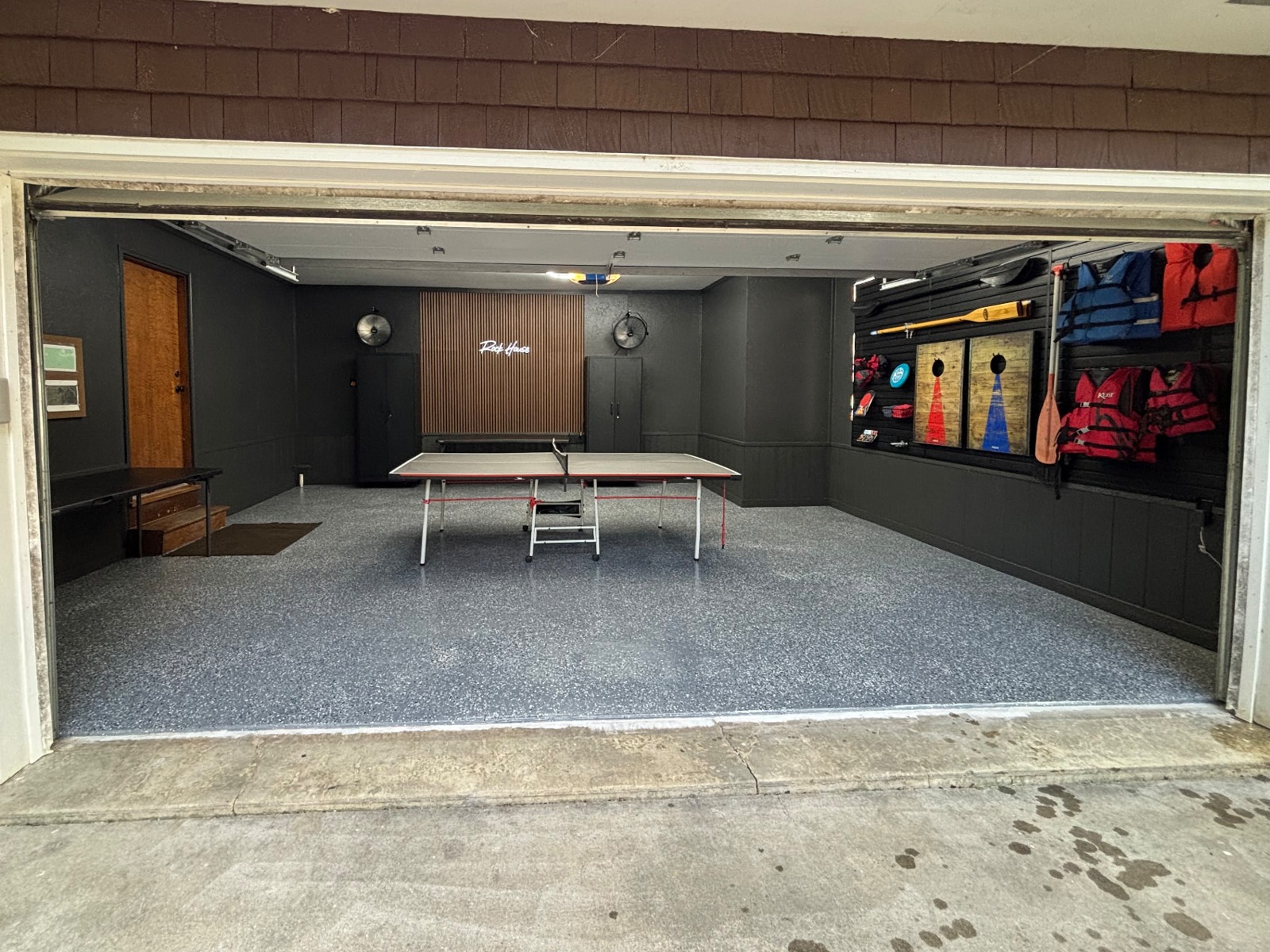 Signature Transformation before and after: dated garage turned into a premium lifestyle space with hexagon lighting, dark cabinetry, feature wall, and polished flake floor — after